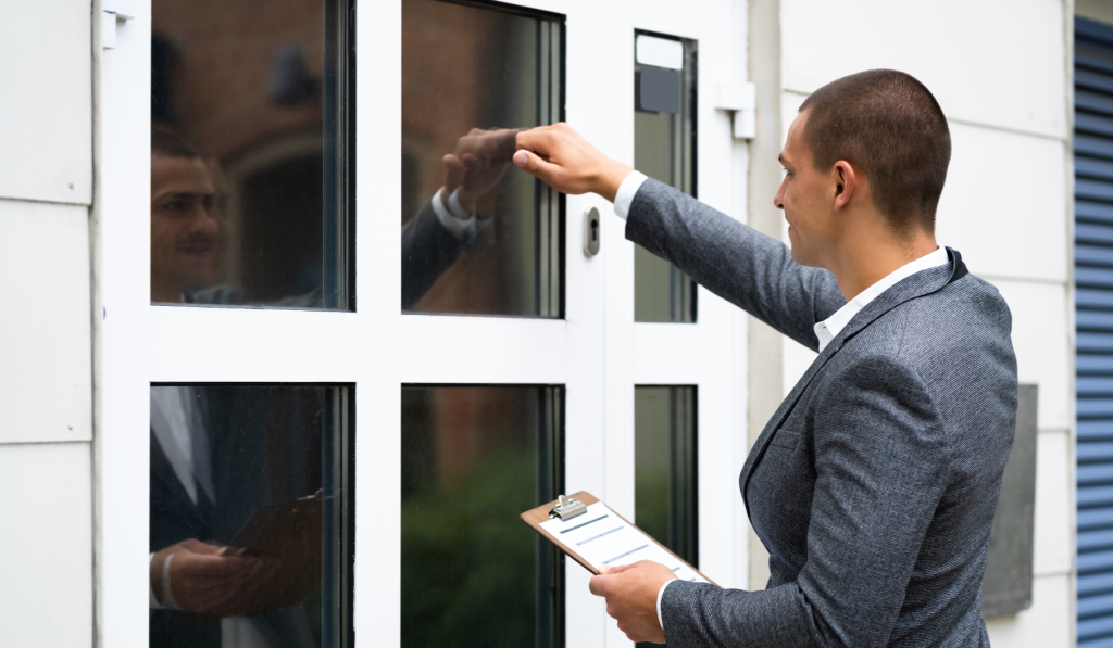 Man holding a clipboard knocking on a front door